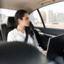 woman working her laptop car 90x90